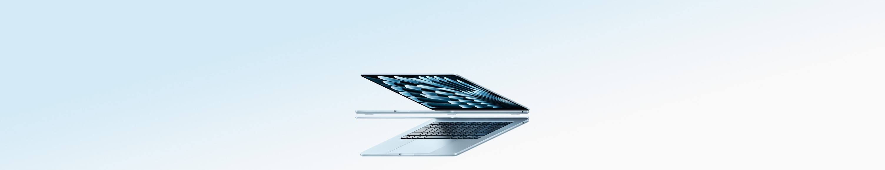 جهازا لابتوب MacBook Air باللون الأزرق السماوي مفتوحان على شكل سهم، ما يُبرز نحافة التصميم